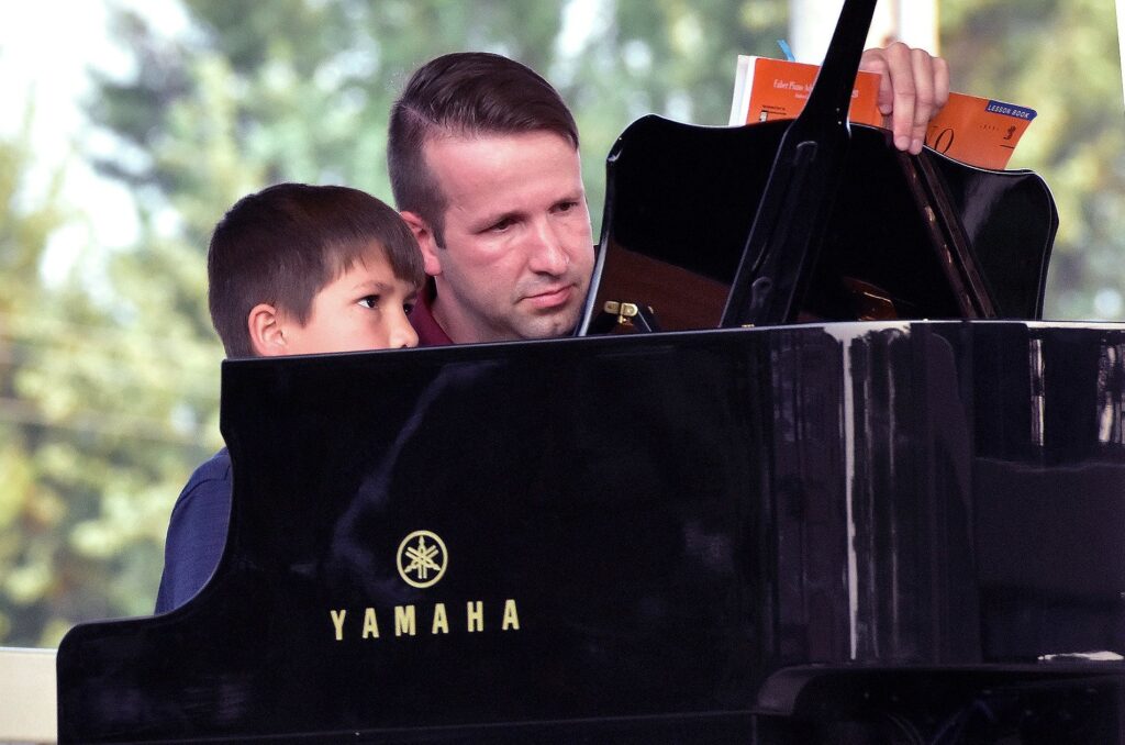 a man sitting in front of a piano