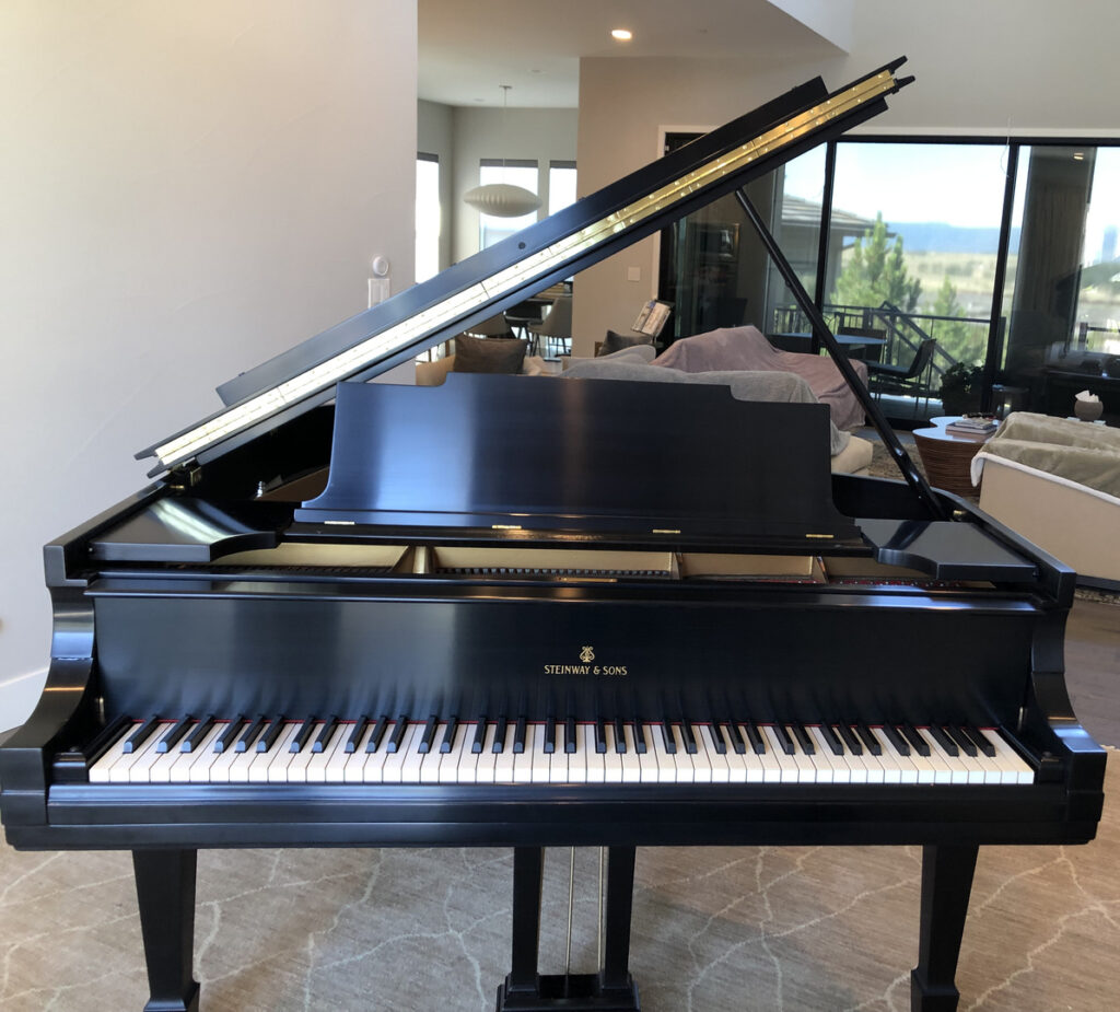 A piano sitting near a beautiful home's sitting room.